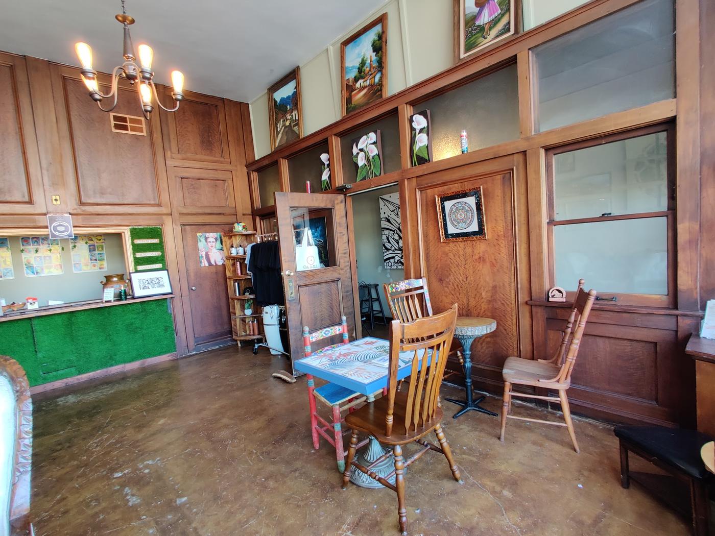 Inside Café Ollama: full height wood panelling, a brass chandelier, Mexican folk art and hand painted furniture.